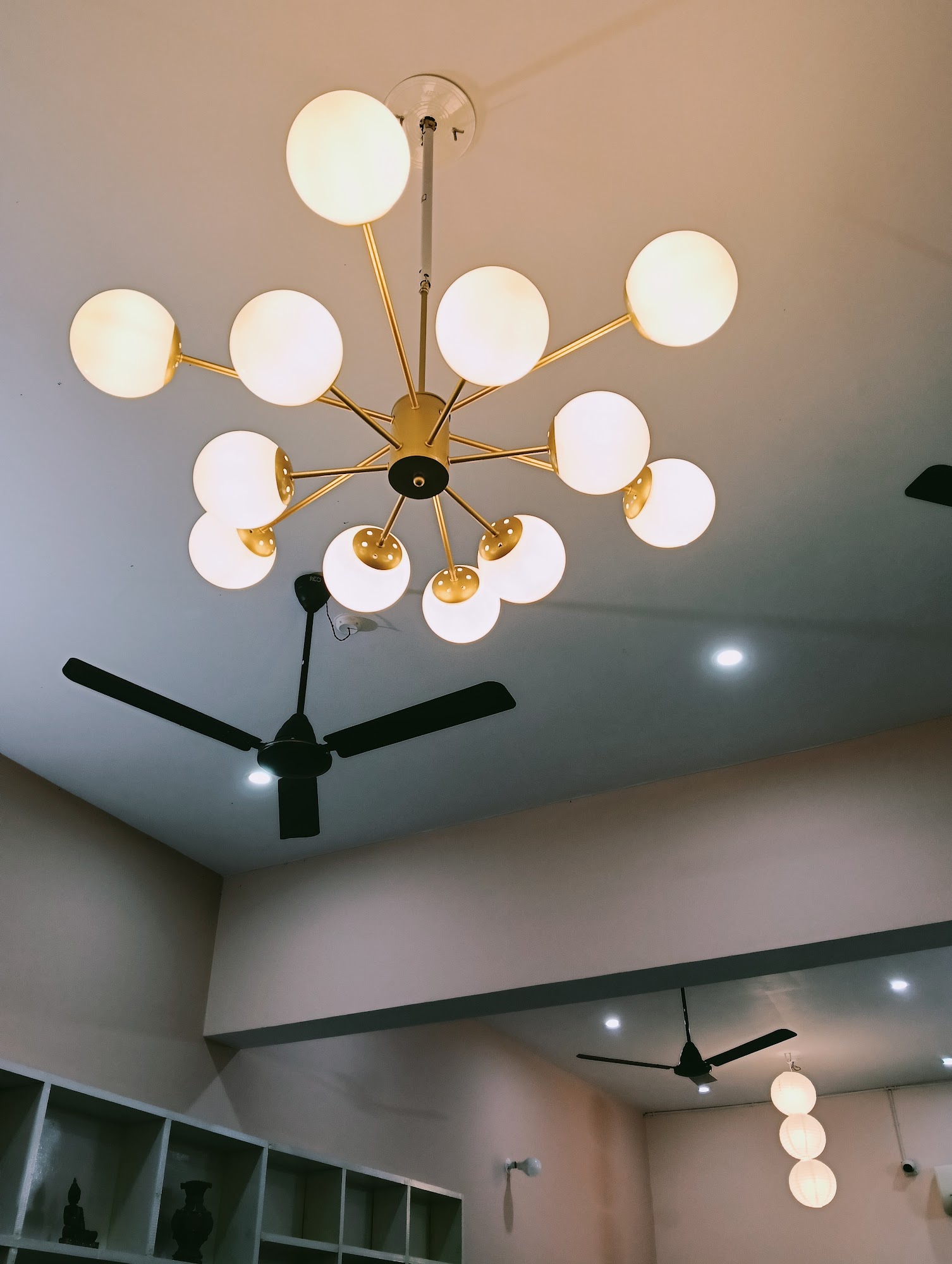 Warm brass chandelier lighting the cafe interior